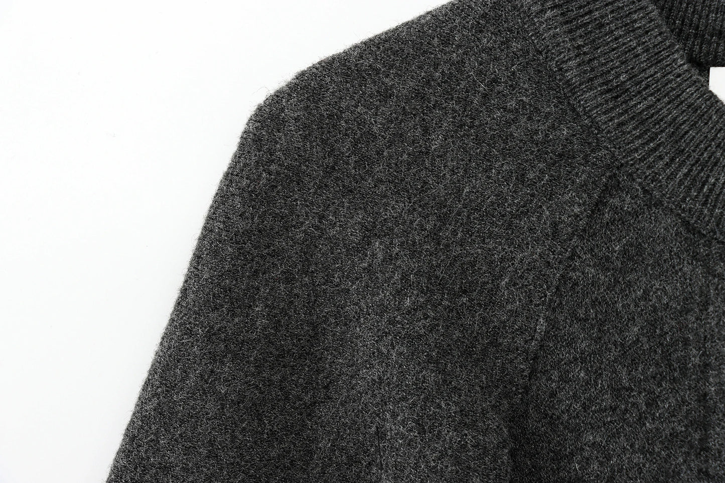 Close-up of a dark gray cape on a white background