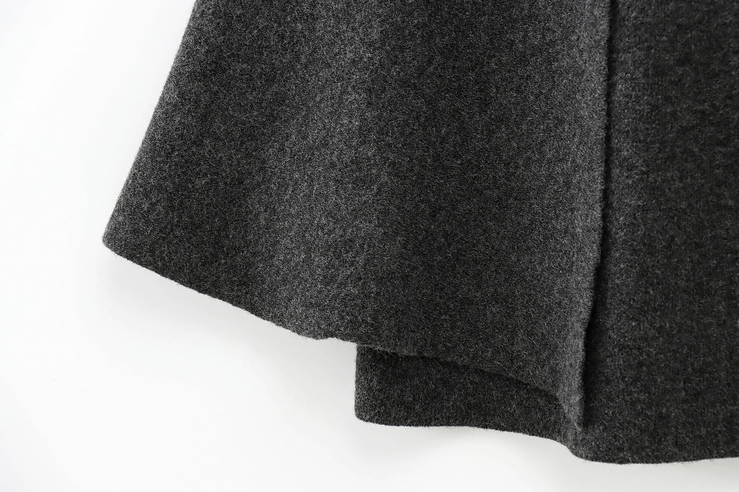 Close-up of a dark gray cape on a white background