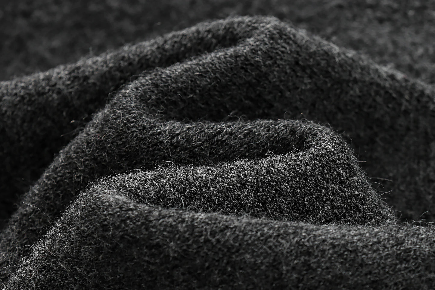 Close-up of dark textured fabric with a focus on texture and color.