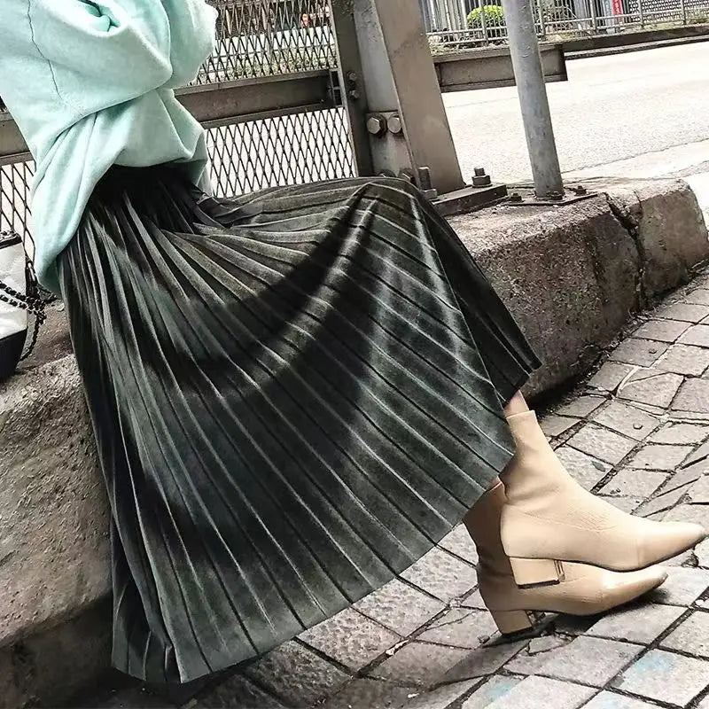 Stylish army green pleated velvet midi skirt with a high waist and soft texture, perfect for winter outfits.