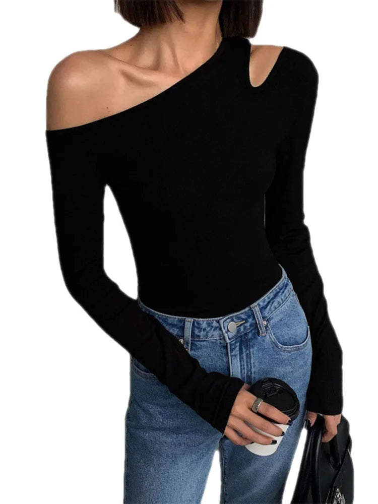 Model showcasing the black asymmetric off-shoulder top, highlighting its stylish design and fit.