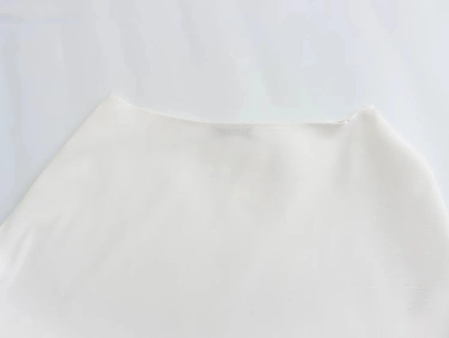 Side view of the asymmetrical skew collar t-shirt highlighting its modern silhouette