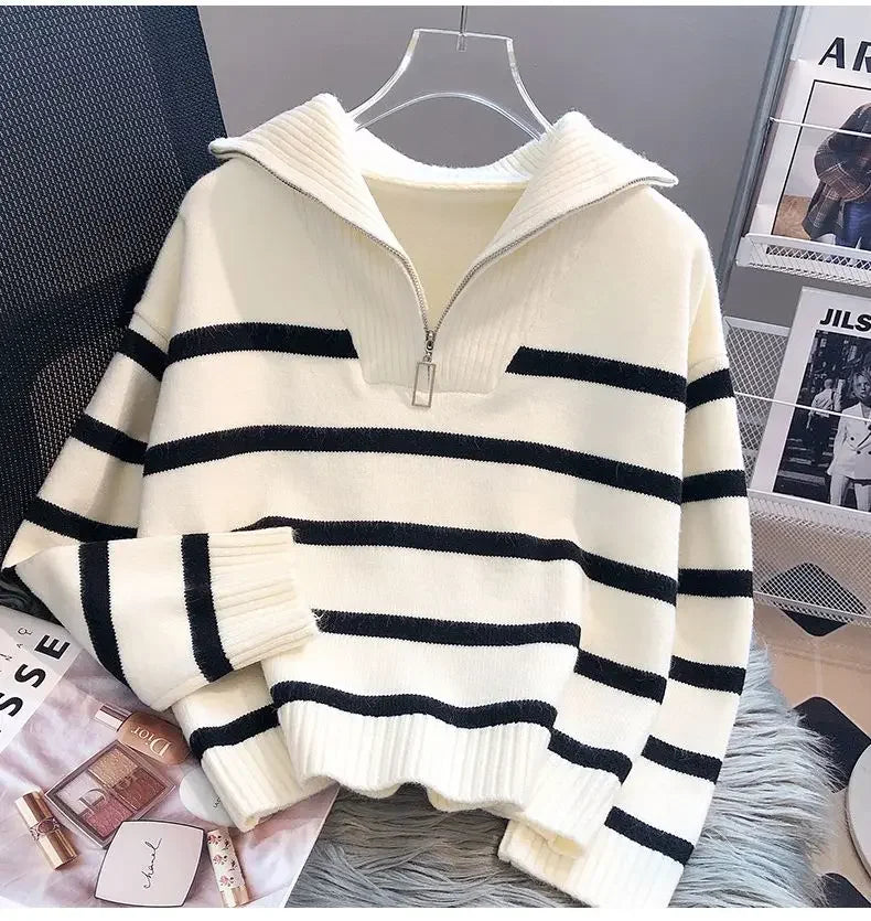 Angled view of beige striped zipper pullover sweater with black stripes, highlighting the collar and casual style.