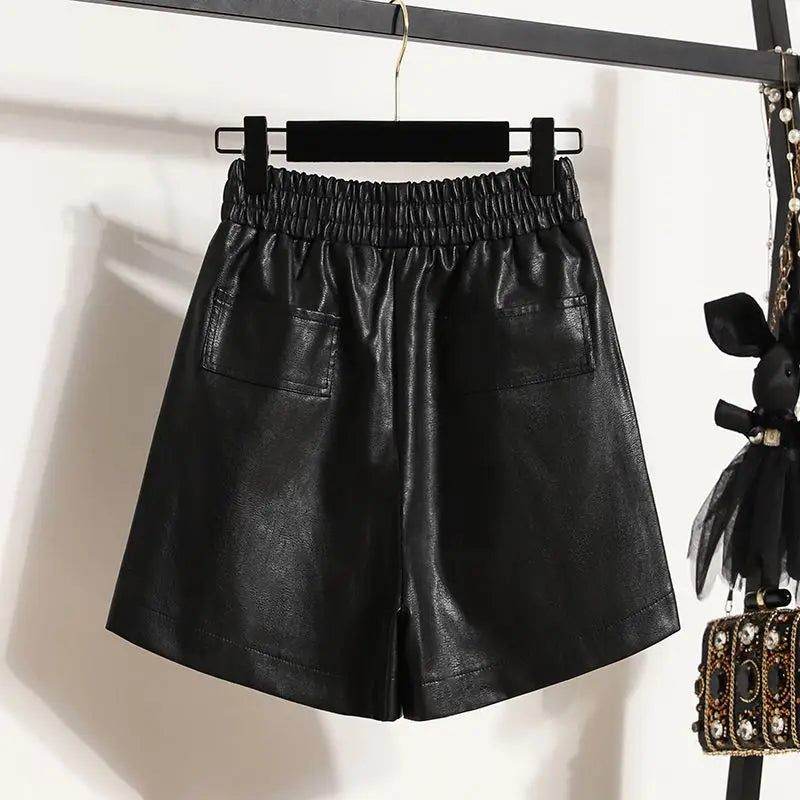 back of the Black High-Waist Leather Shorts displayed on a hanger, showcasing their stylish design and material.