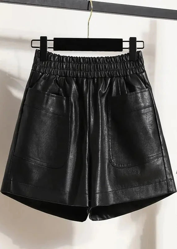 Black High-Waist Leather Shorts displayed on a hanger, showcasing their stylish design and material.