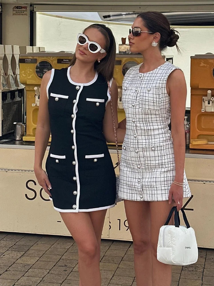 Two models wearing black knit ribbed mini dresses, displaying different styles and fits.