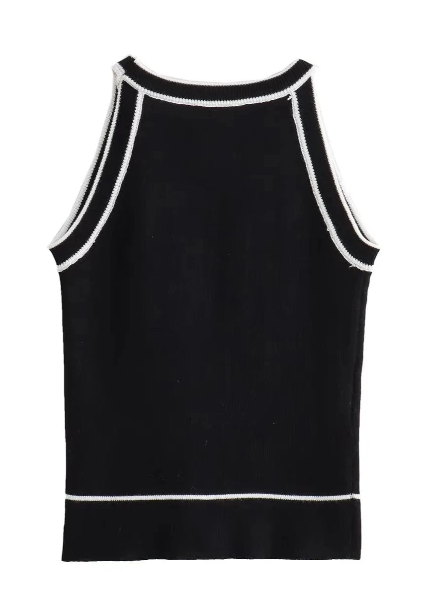 Black knitted crop tank with contrasting black and white striped pattern, displayed on a clean white background