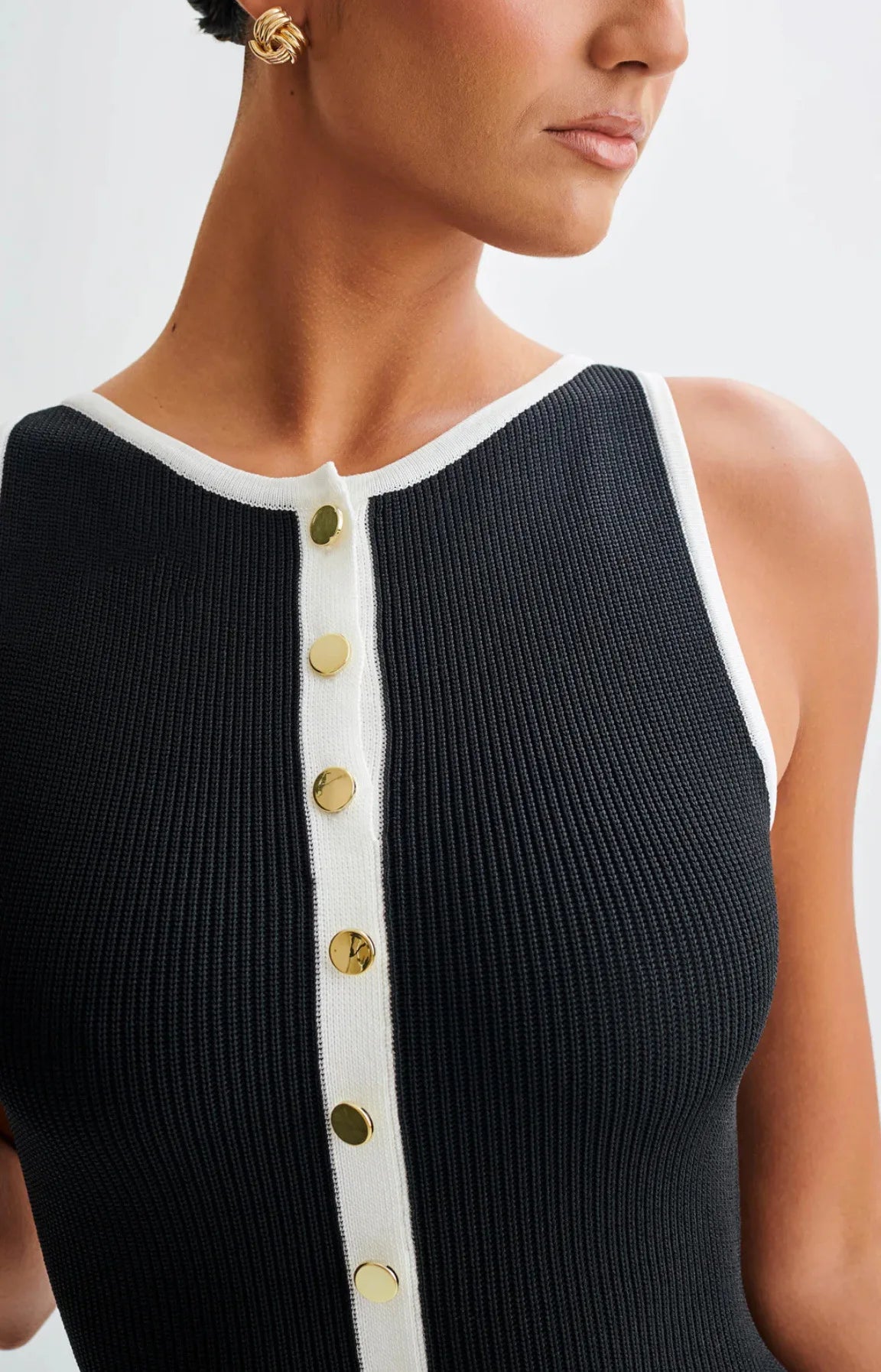 Close-up of the black knitted mid-calf dress, focusing on the fabric texture and detailing.