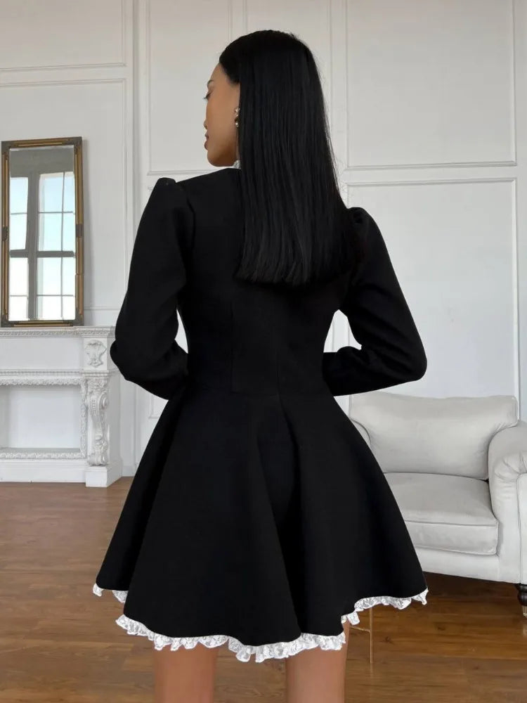 Model in black lace mini dress, back view showing the dress fit and lace texture.