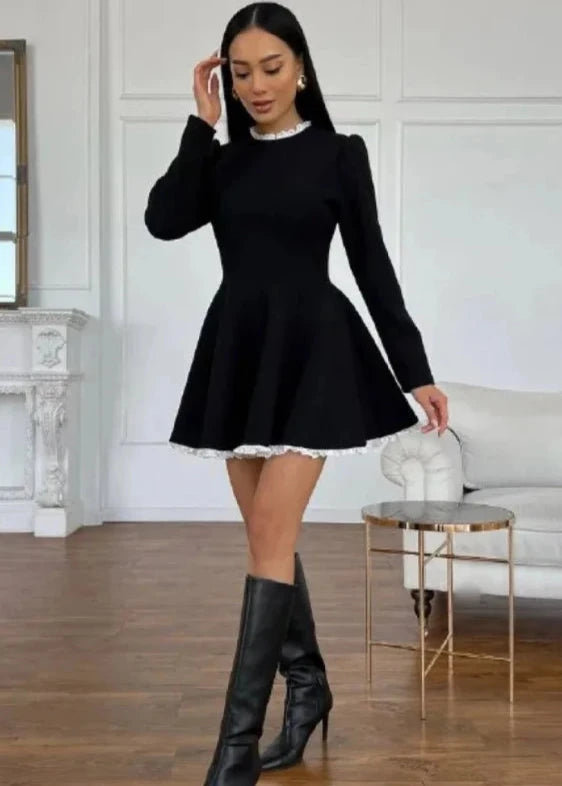 Model wearing the black lace mini dress, showcasing the front view with intricate lace details