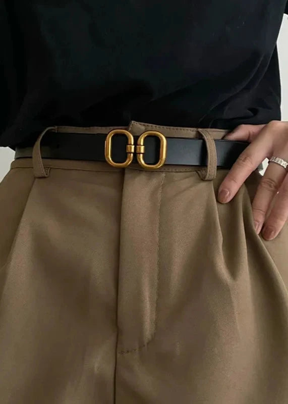 Classic black leather belt with a polished metal buckle, ideal for versatile styling.
