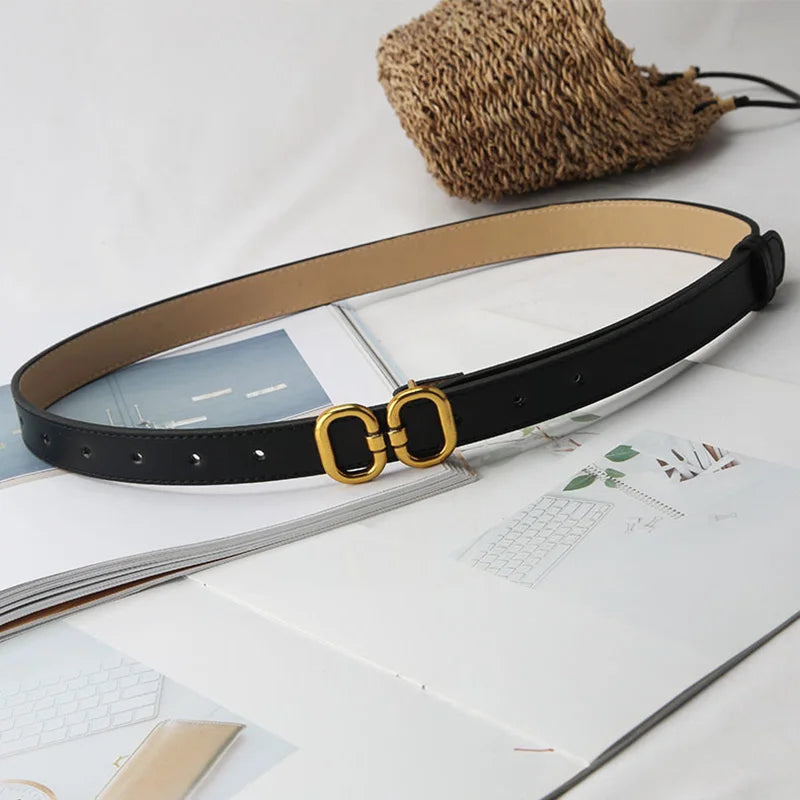 black leather belt featuring a chic metal buckle for a refined touch.