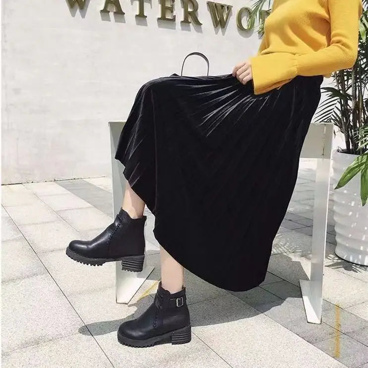 Chic black pleated velvet midi skirt with an A-line silhouette and elastic high waist, perfect for elegant autumn and winter outfits.