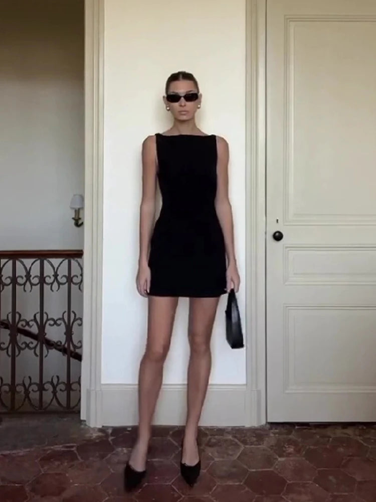 Sleek black sleeveless mini bodycon dress, designed for a flattering, figure-hugging fit and elegant style.