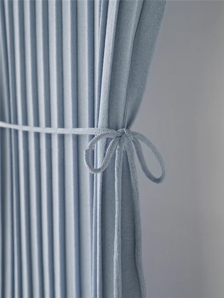 Elegant blue knitted tank dress featuring a loose fit and side split for a sophisticated summer look.