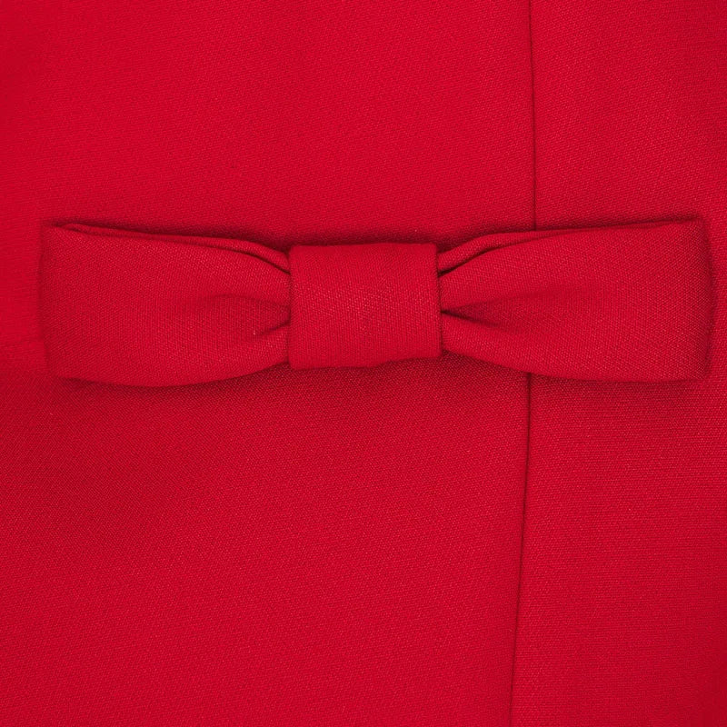 Close-up of the bow detail on the red Bows Splice Mini Dress, highlighting the elegant splice design.