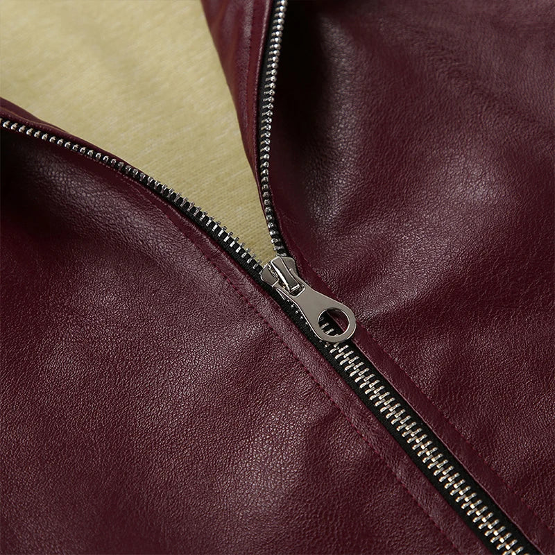 Close-up of the closure on the burgundy faux leather jacket, showcasing the stylish gold button accents.