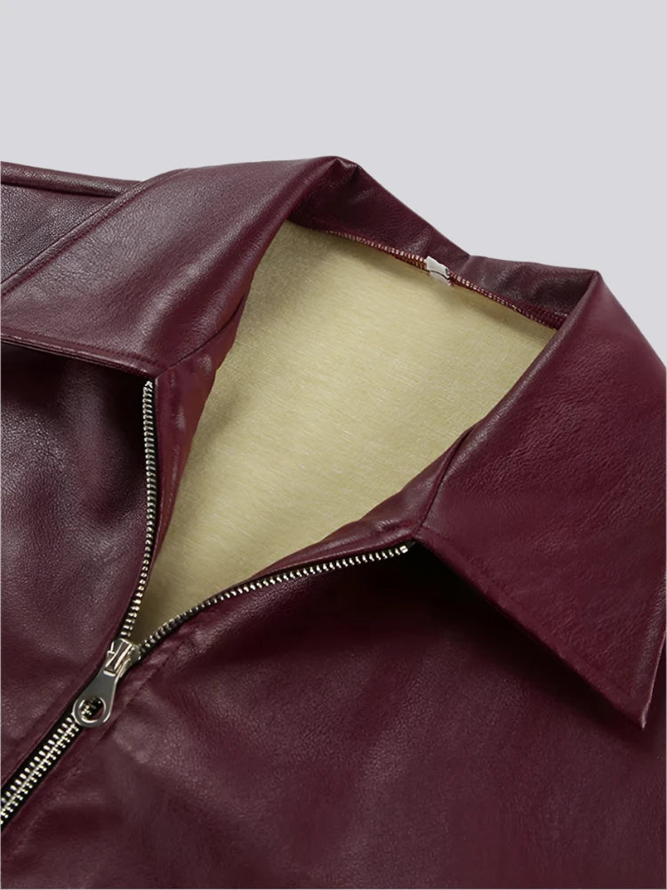 Close-up of the burgundy faux leather jacket collar, showing fine stitching and soft texture.