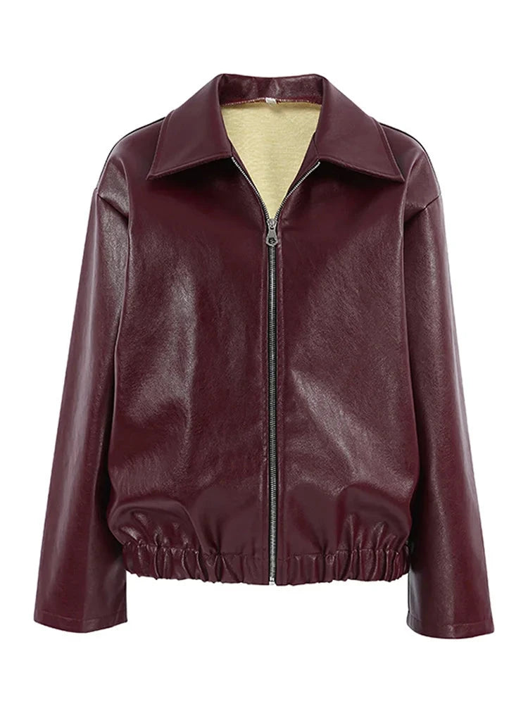 Burgundy faux leather jacket displayed without a model, highlighting its sleek design and tailored structure.