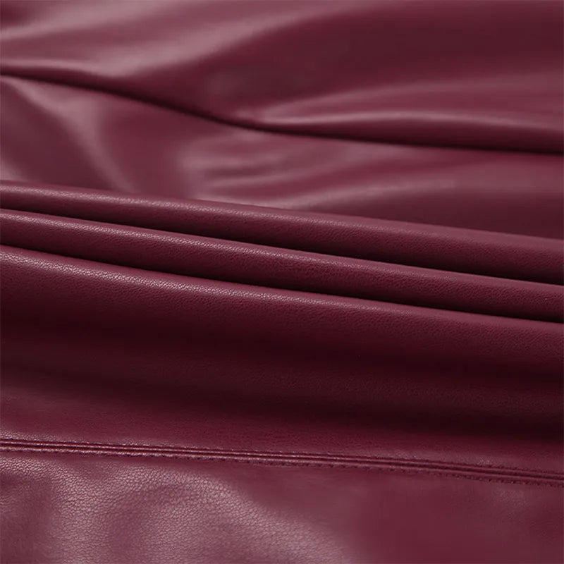 Zoom on the fabric folded of the Burgundy Leather Mini Skirt, illustrating its supple material.