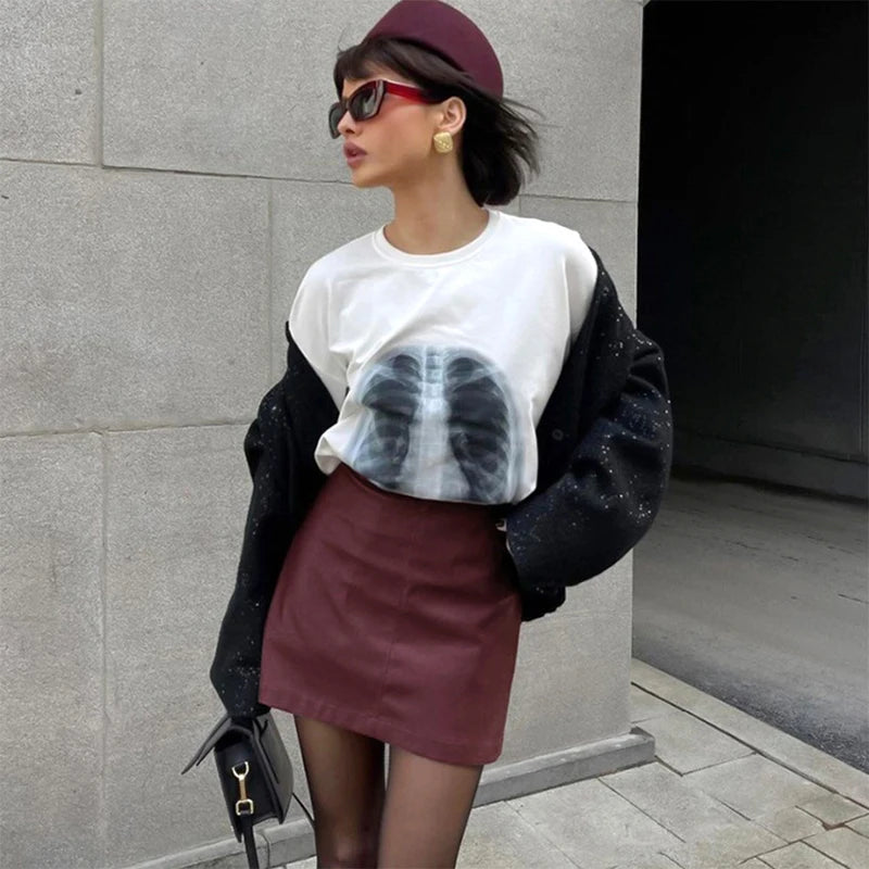 Side view of the Burgundy Leather Mini Skirt, highlighting its flattering silhouette.