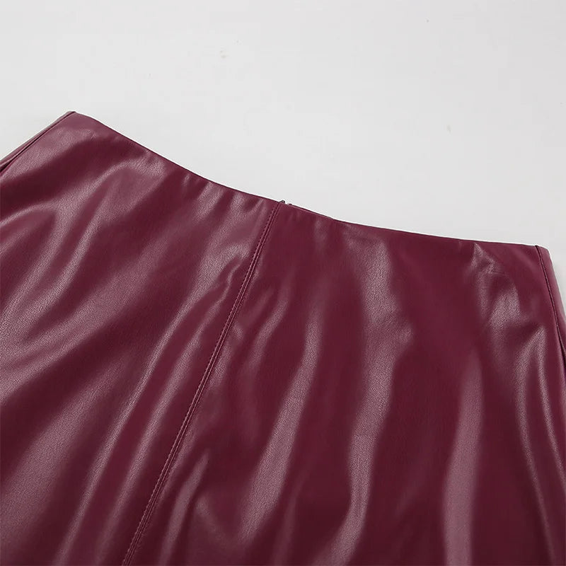 Close-up of the waist of the Burgundy Leather Mini Skirt, highlighting its tailored fit.