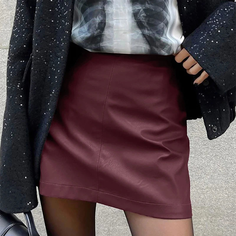 Close-up of the model wearing the Burgundy Leather Mini Skirt, emphasizing its luxurious texture.