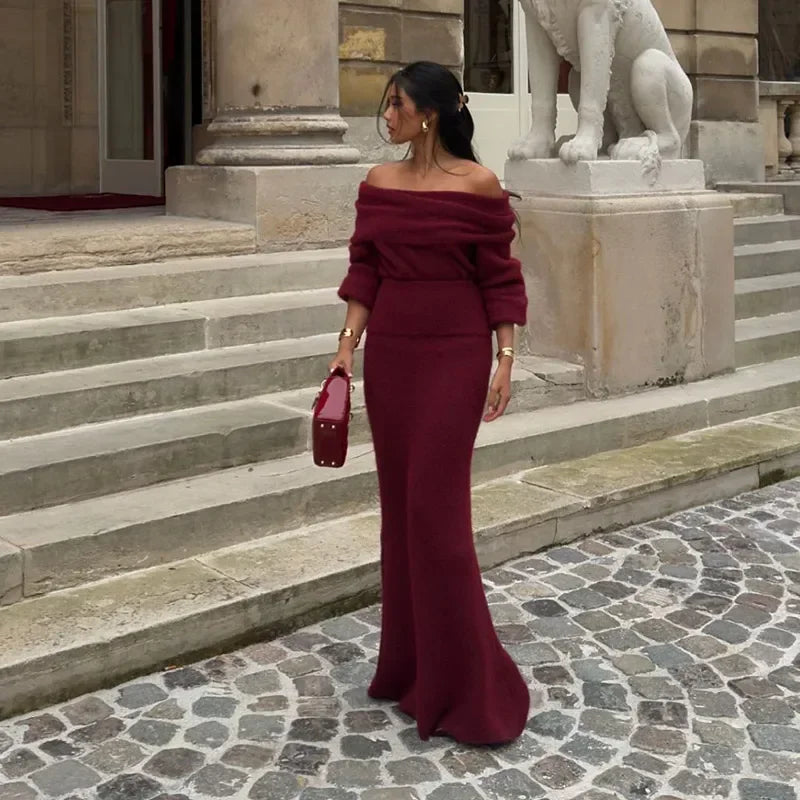 Side angle view of the Burgundy off-shoulder knitted maxi dress showing its elegant silhouette.