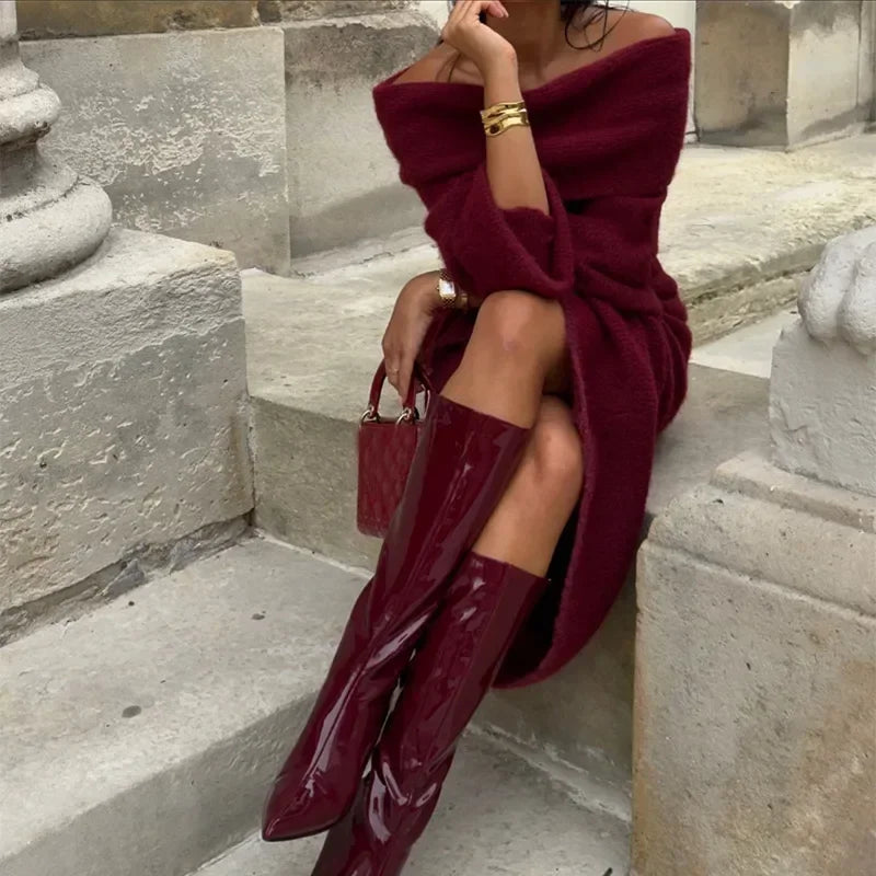 Model sitting in Burgundy off-shoulder knitted maxi dress, exuding comfort and style.