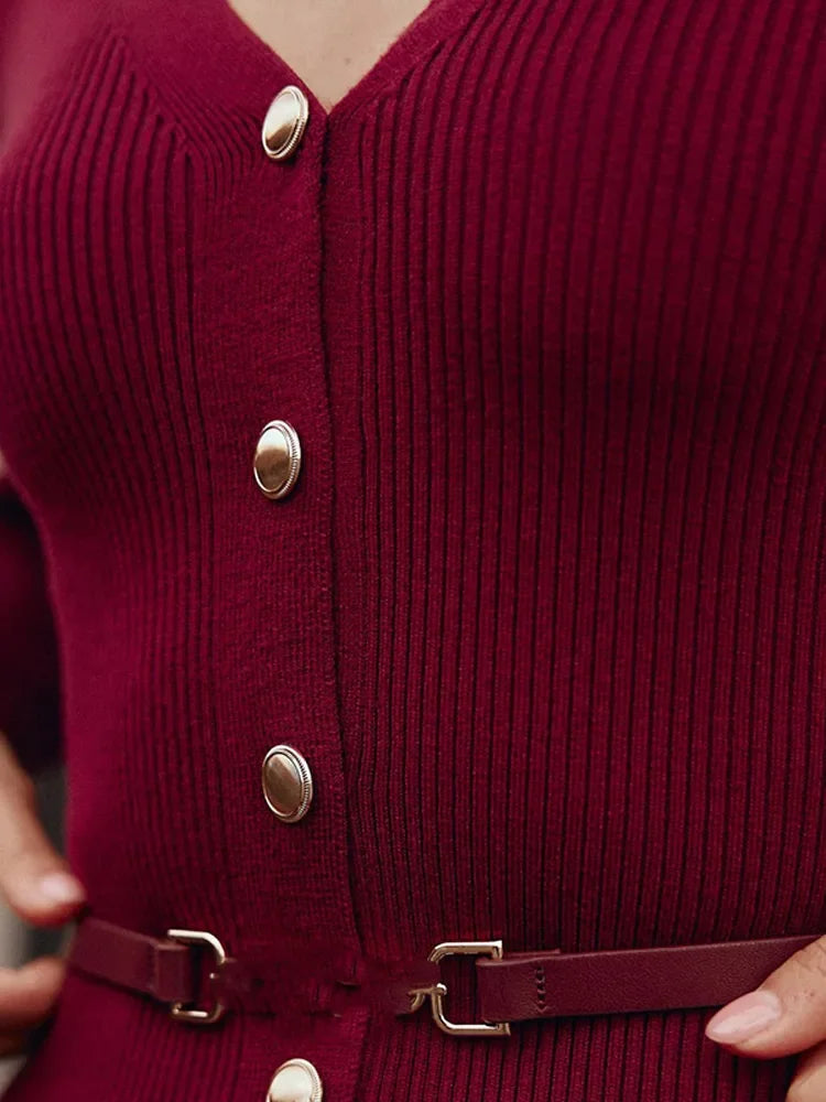 Close-up of the Burgundy V-neck knitted long dress buttons, emphasizing the details.