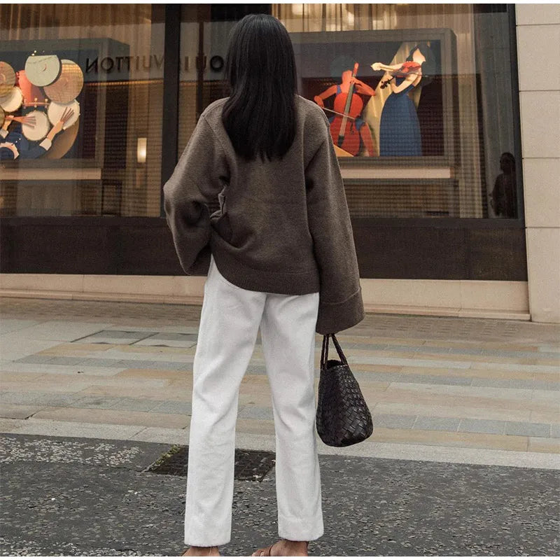 Back view of the brown V-neck knitted cardigan, emphasizing its casual fit and knit texture.