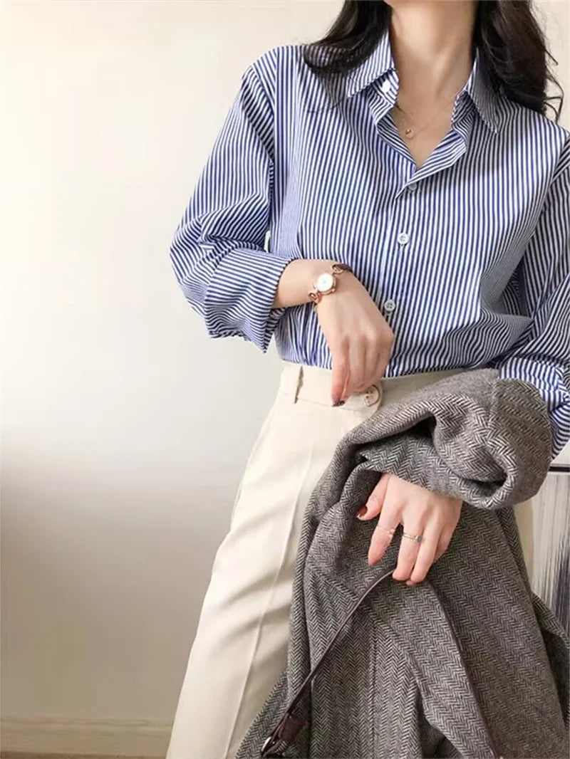 Classic striped blouse styled in chic workwear, perfect for a stylish professional