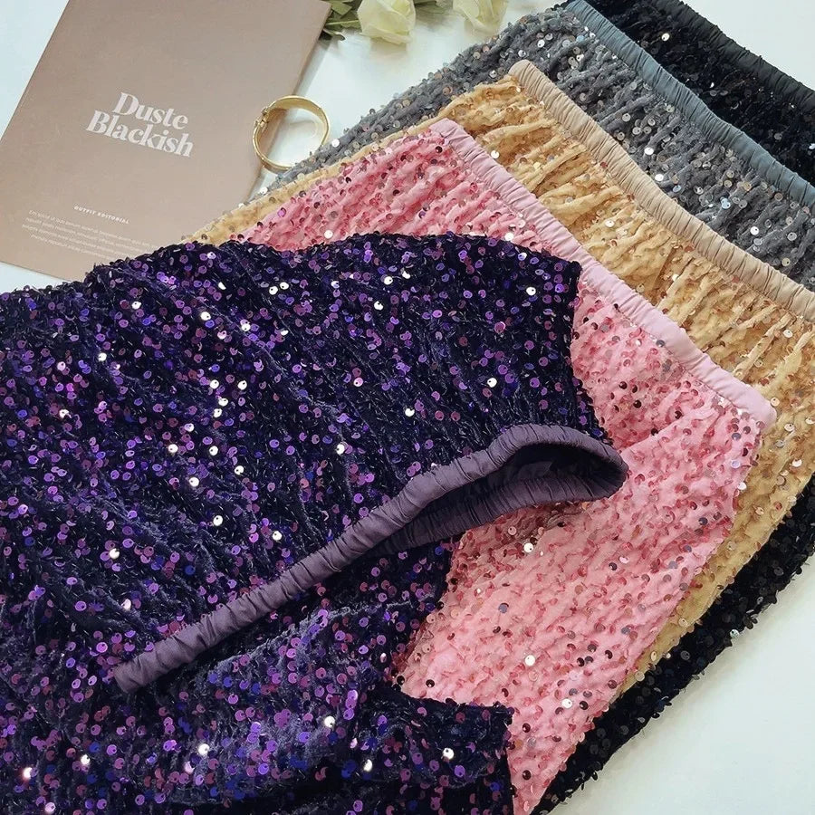 Close-up shot of velvet sequin midi skirts in various colors, highlighting the shimmering sequins and luxurious velvet texture.