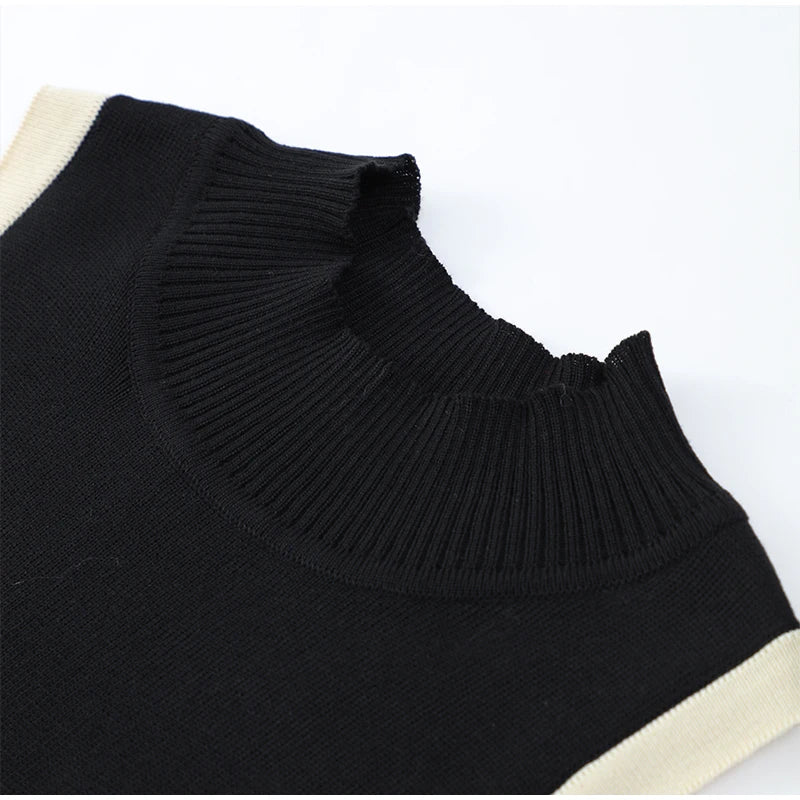 Close-up of the collar of the Color Blocked Knitted Mini Dress, showcasing the refined neckline and color contrast.