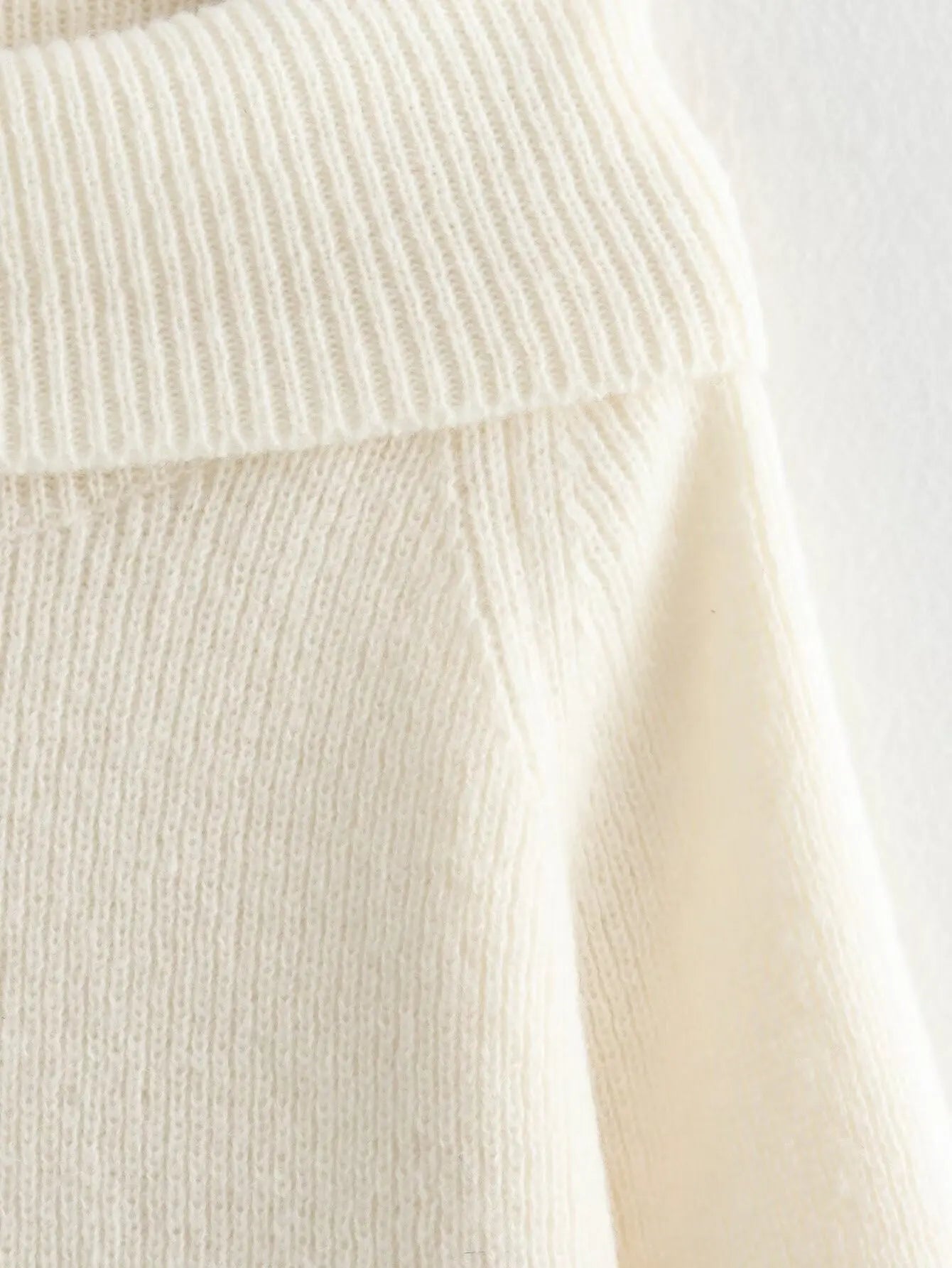 Cozy beige off-shoulder knitted sweater, designed for effortless warmth and style