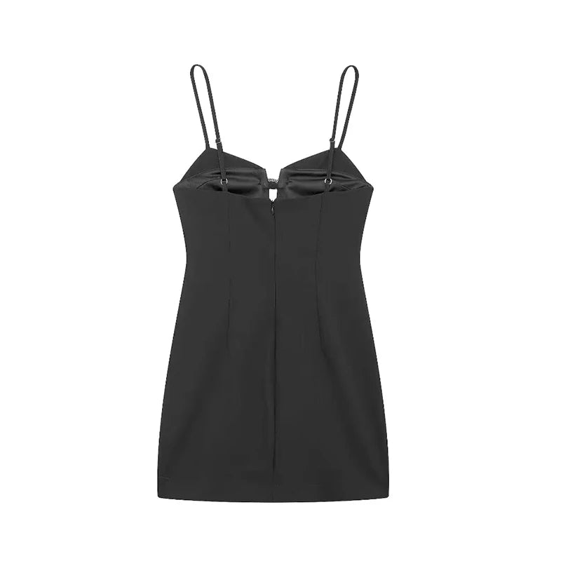 back of black mini dress showcasing the flattering silhouette and diamond bow accents.