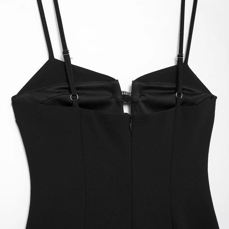 Elegant black mini dress styled for festive occasions, featuring diamond bow details.
