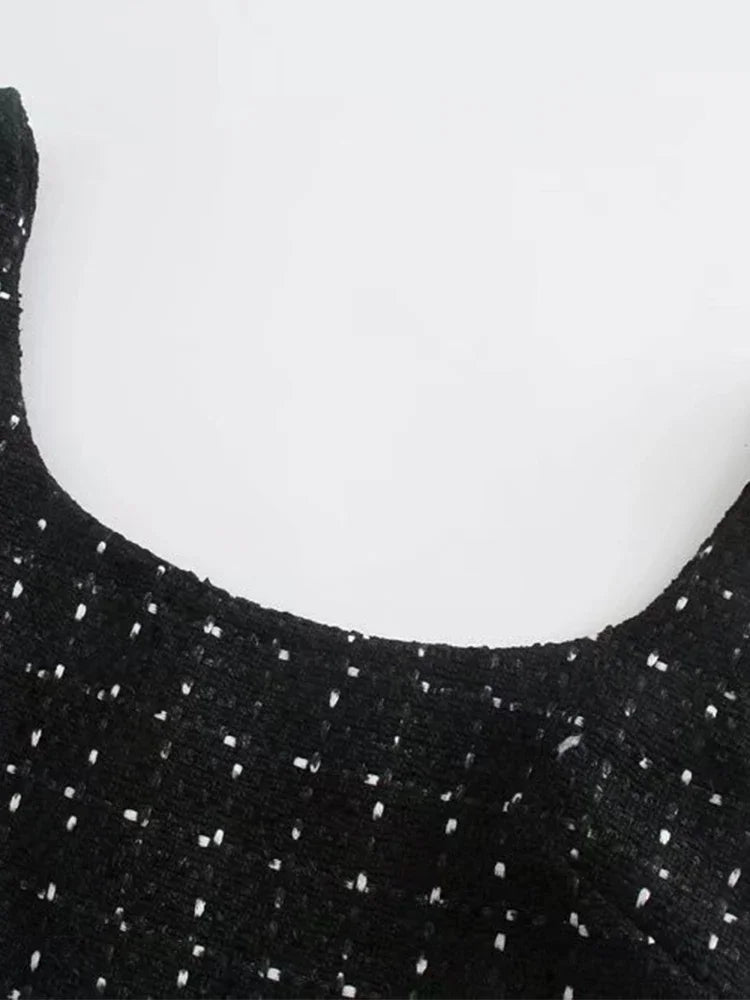 Elegant black hollow-back tweed dress, ideal for holiday celebrations and parties.