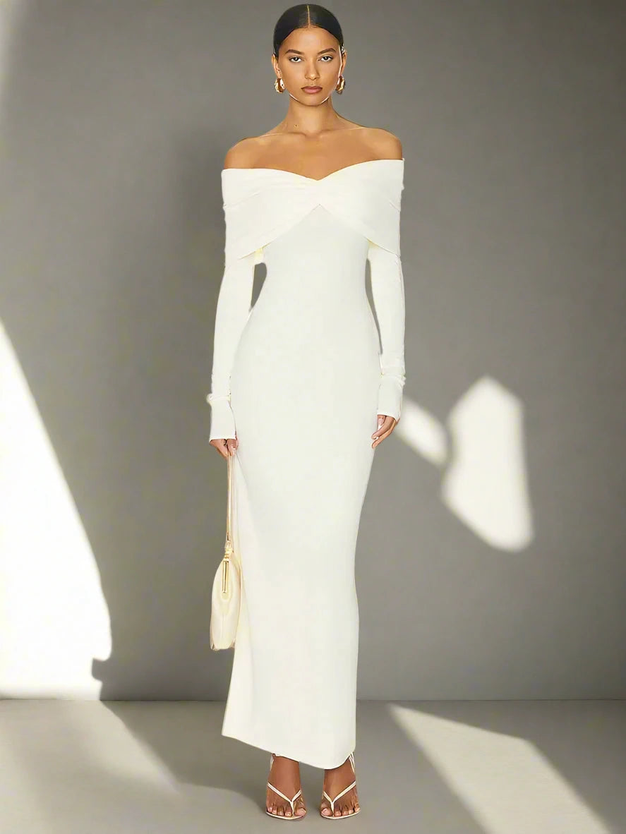 Back view of the white off-shoulder maxi dress showcasing its graceful sheath silhouette.