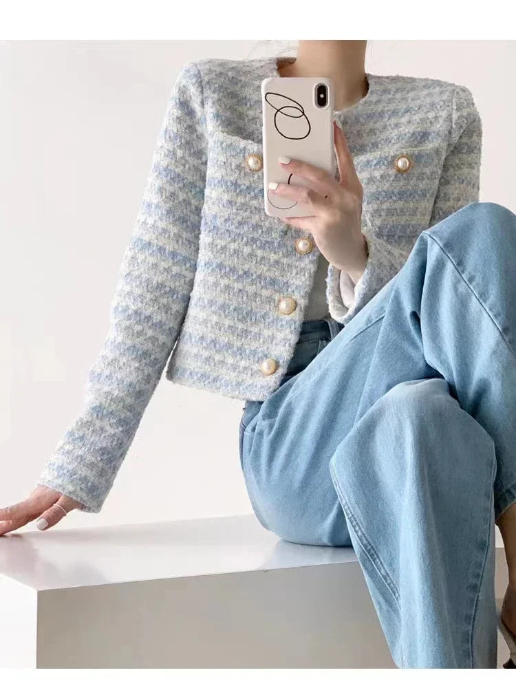 Tweed jacket in white, blue, and grey, combining classic elegance and modern style, perfect for a sophisticated wardrobe.