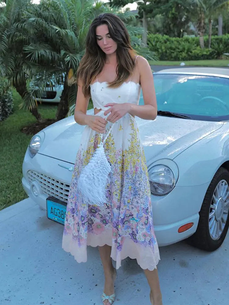 Feminine light purple floral midi dress with a flowy silhouette and lace-up back, perfect for sunny days.