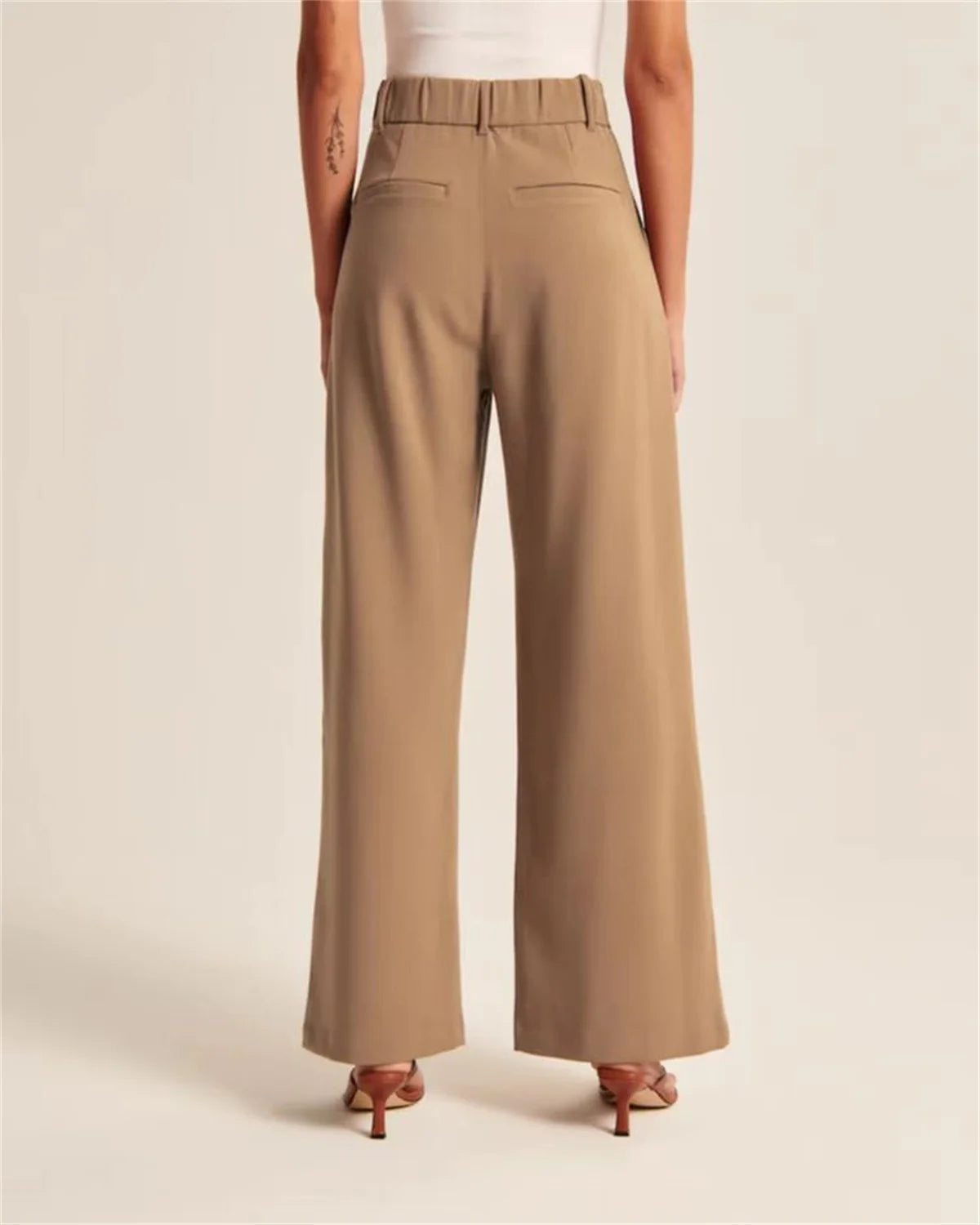Back view of Brown High-Waisted Palazzo Pants with stretch waist detail, perfect for workwear.