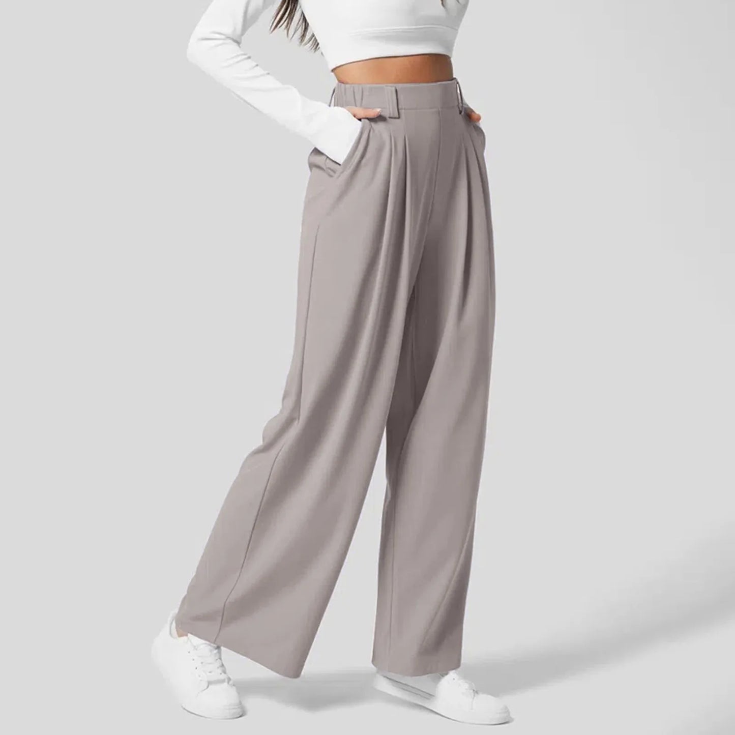 Side view of Grey High-Waisted Wide-Leg Trousers highlighting the relaxed fit and wide-leg style for a modern office look.