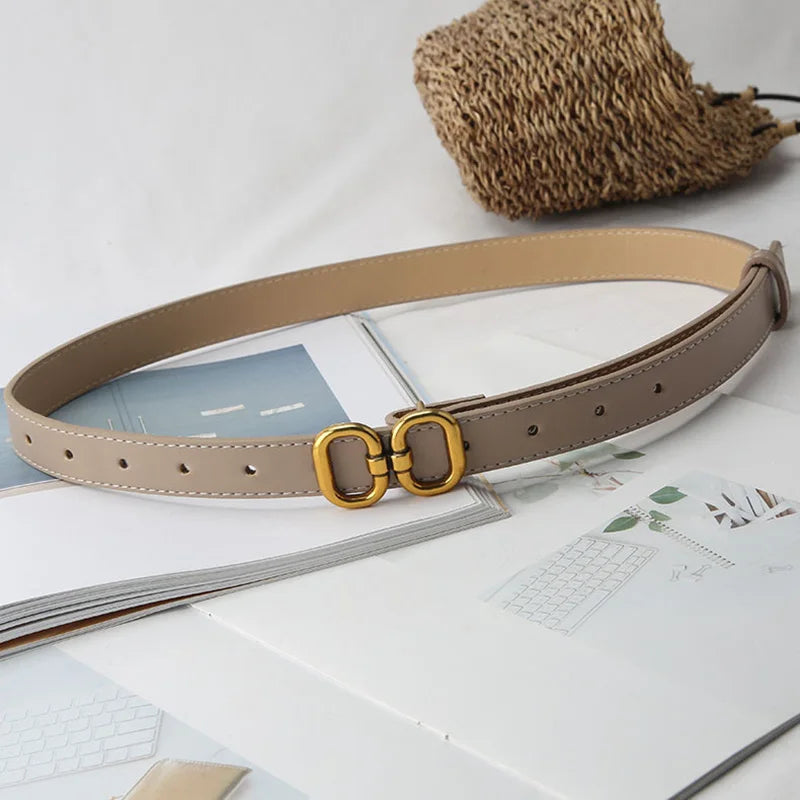 Khaki leather belt with a stylish metal buckle, adding a subtle touch to any outfit.