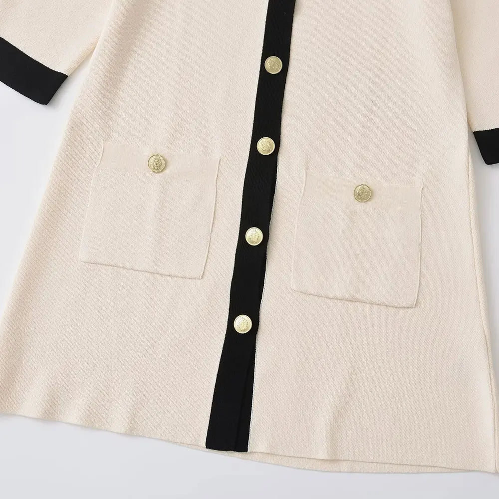 Old money-inspired knitted mini dress with cream beige fabric, black contrast trim, and refined gold buttons