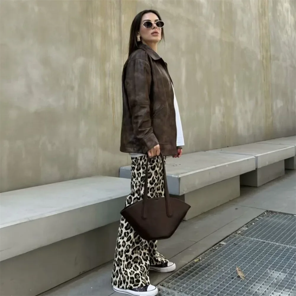 Side view of Leopard Print Pants on brunette model, showcasing the wide-leg fit and bold print.