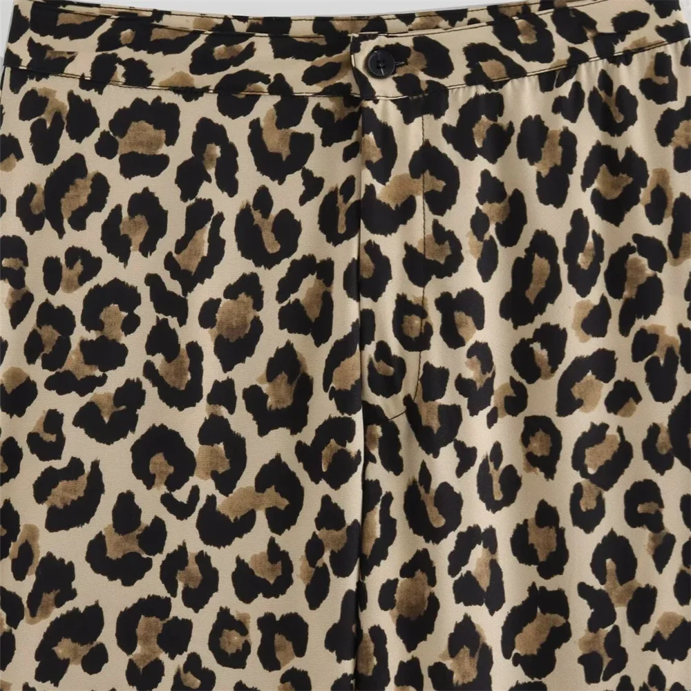 Front view close-up of Leopard Print Pants, showing button and pocket details.