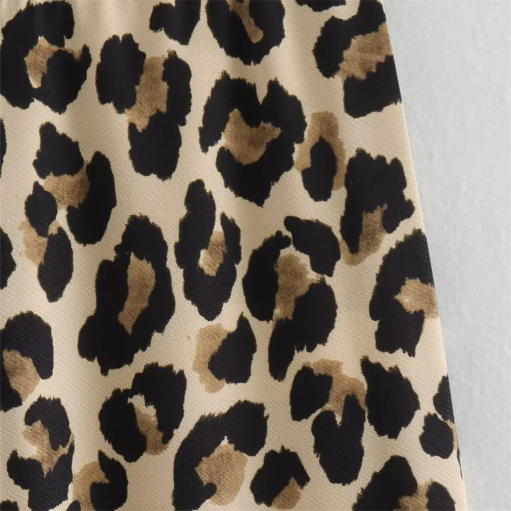 Detailed view of the leopard print pattern, showcasing bold animal print style on pants.