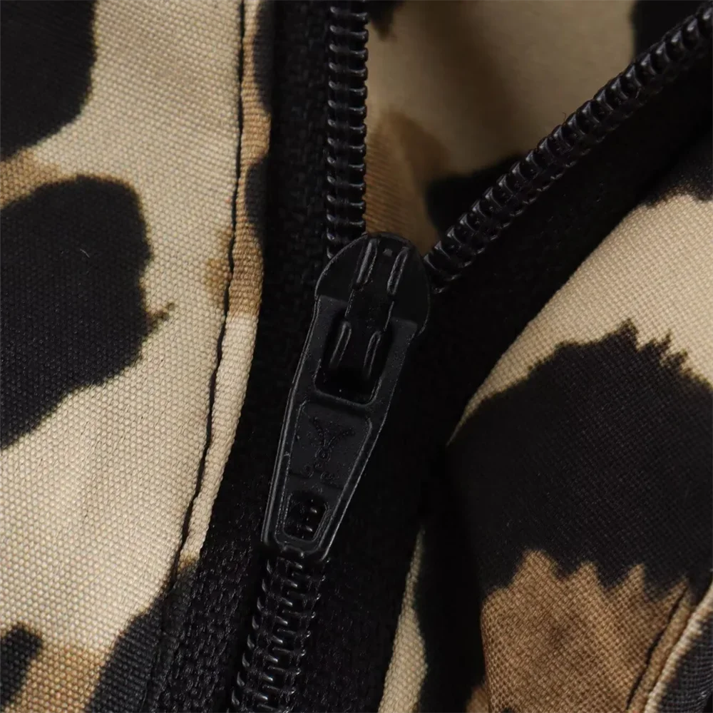 Close-up of the zipper on Leopard Print Pants, highlighting button and front closure details.