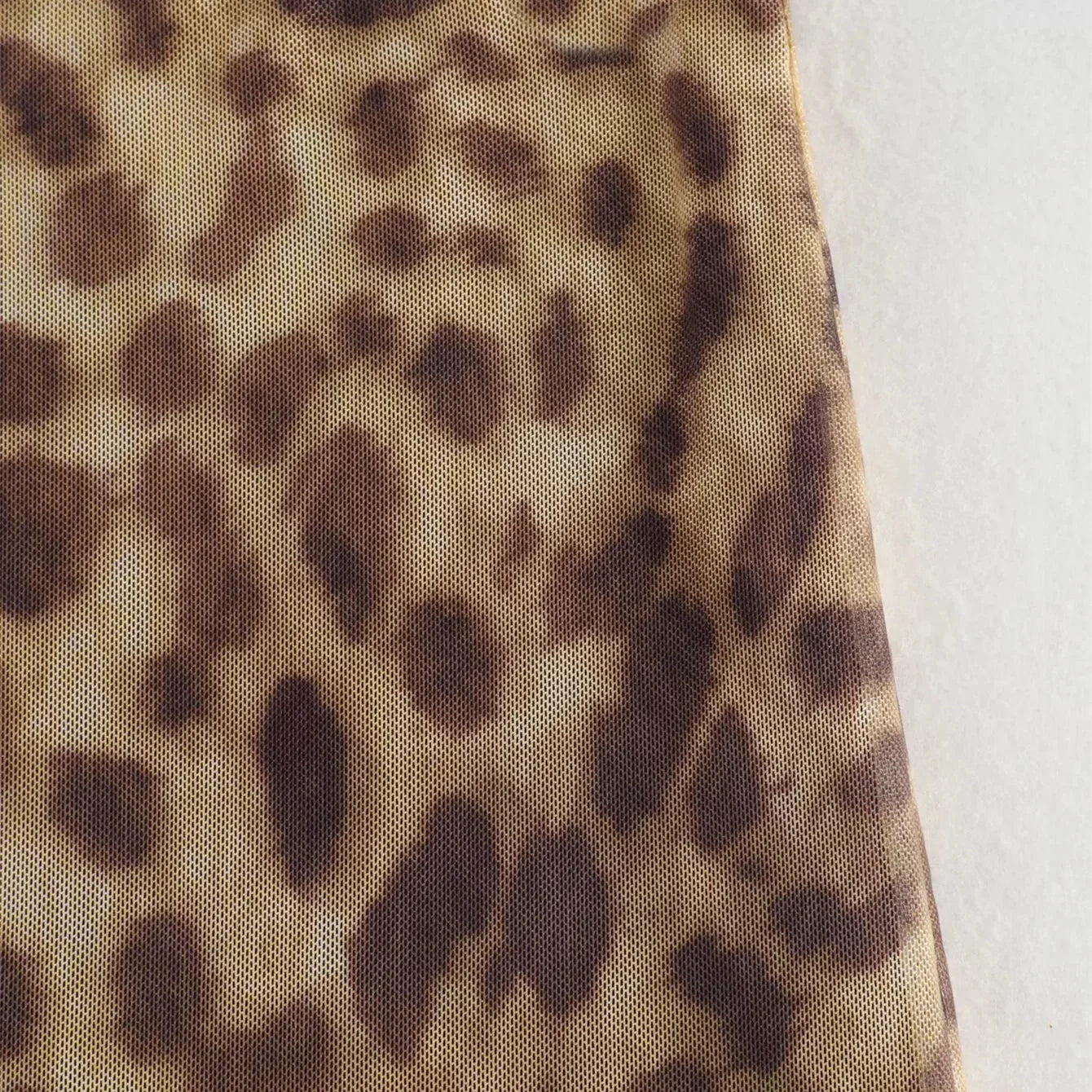 Feminine leopard tulle midi skirt, ideal for casual and formal occasions.
